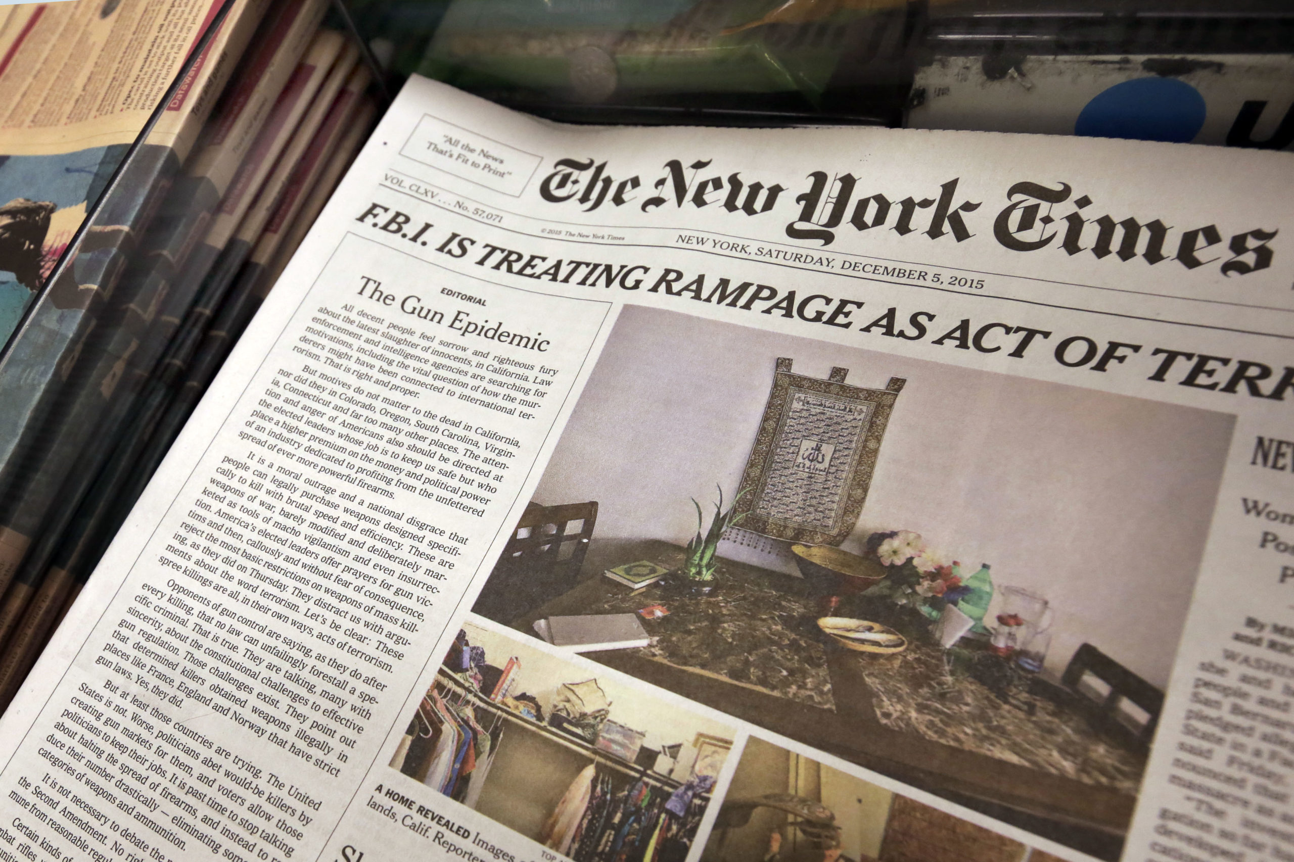 In this photo, an editorial appears on the front page of the New York Times, at a newsstand in New York, Saturday, Dec. 5, 2015. The New York Times is using space on its front page to call for greater gun regulation in the wake of recent deadly mass shootings. Publisher Arthur Sulzberger Jr. says the newspaper is running its first Page 1 editorial since 1920 to "deliver a strong and visible statement of frustration and anguish about our country's inability to come to terms with the scourge of guns." (AP Photo/Richard Drew)