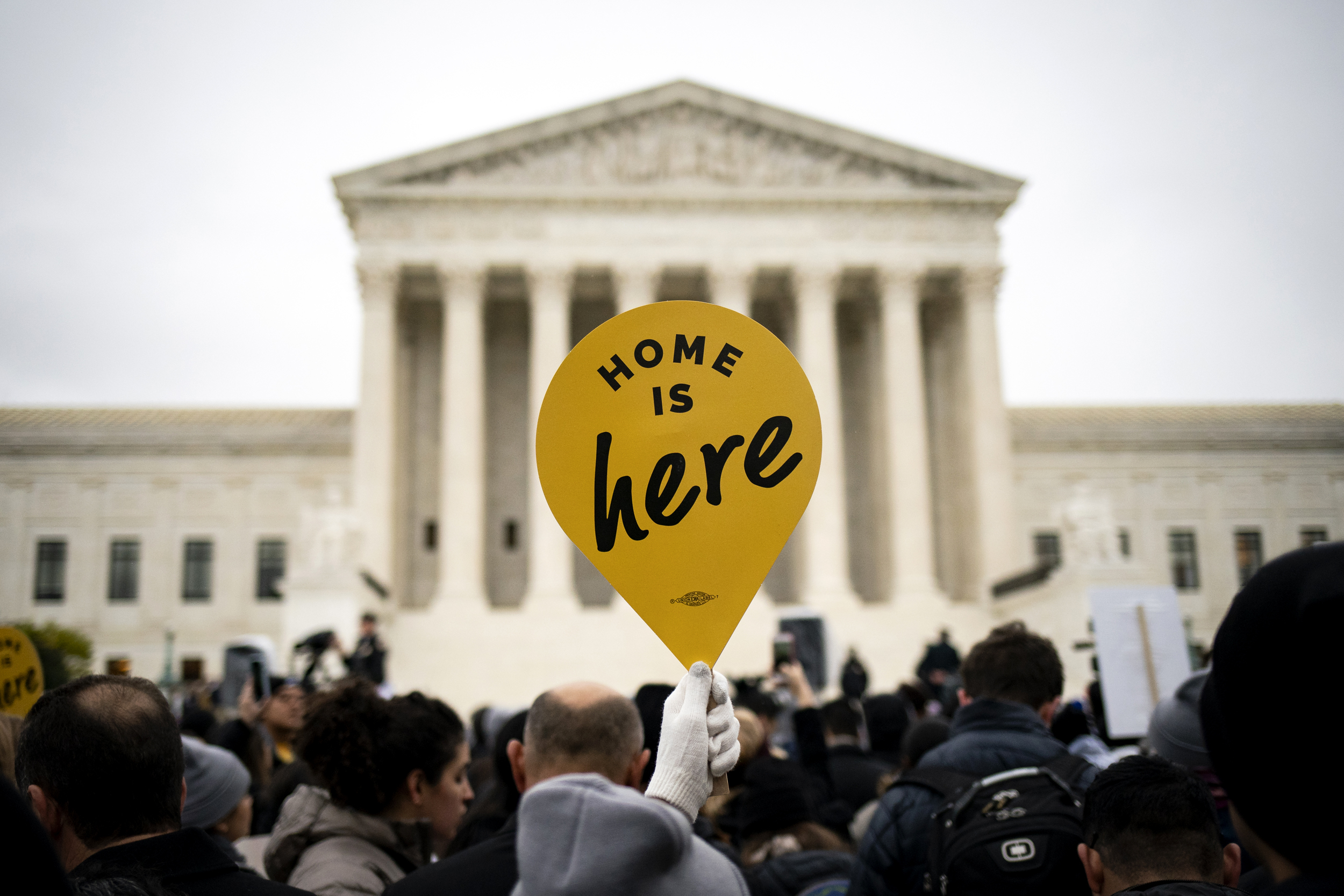 A demonstrator holds a "Home Is Here" sign during a rally supporting the Deferred Action for Childhood Arrivals program (DACA) outside of the Supreme Court in Washington, D.C., U.S., on Tuesday, Nov. 12, 2019. The Supreme Court hears arguments today over the Obama-era DACA program, which the Trump administration wants to undo. Photographer: Al Drago/Bloomberg via Getty Images